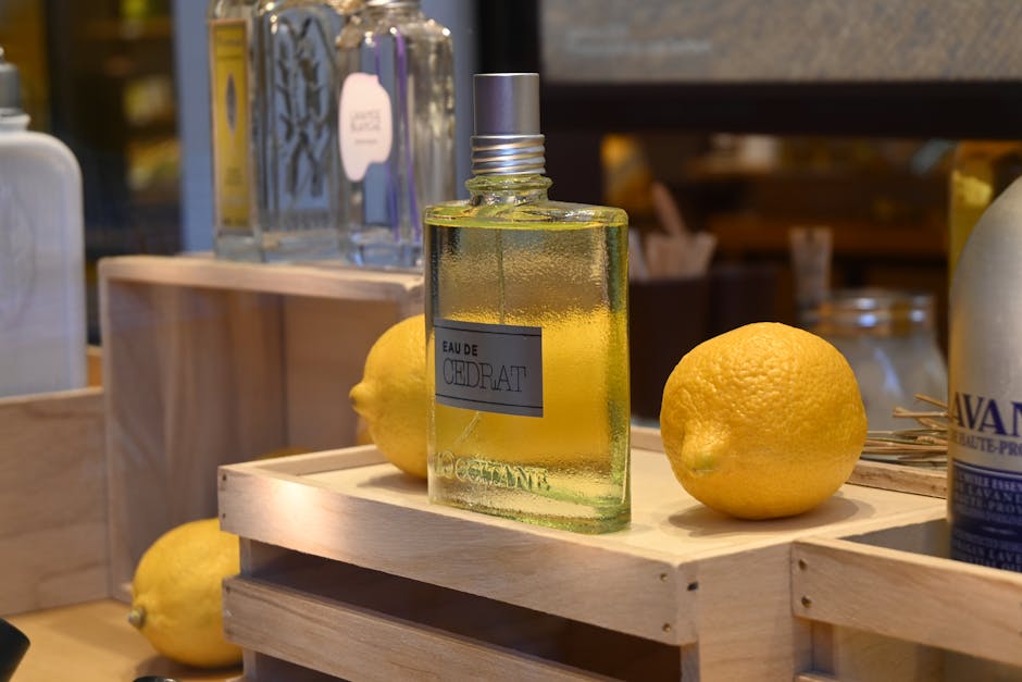 Sliced citrus fruits beside a glass perfume bottle representing fresh summer fragrance notes