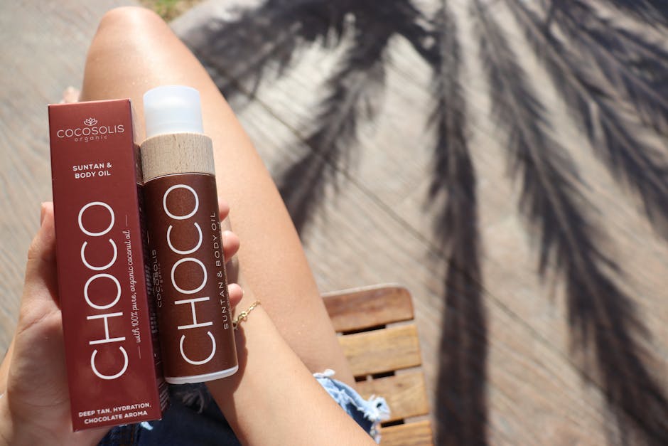 Luxury self-tanning drops and gradual tanner bottles arranged on a marble surface