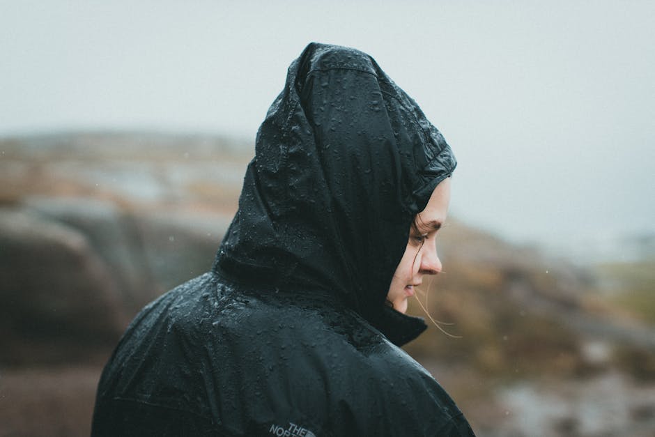 Woman wearing a lightweight waterproof jacket and wellington boots at an outdoor music festival