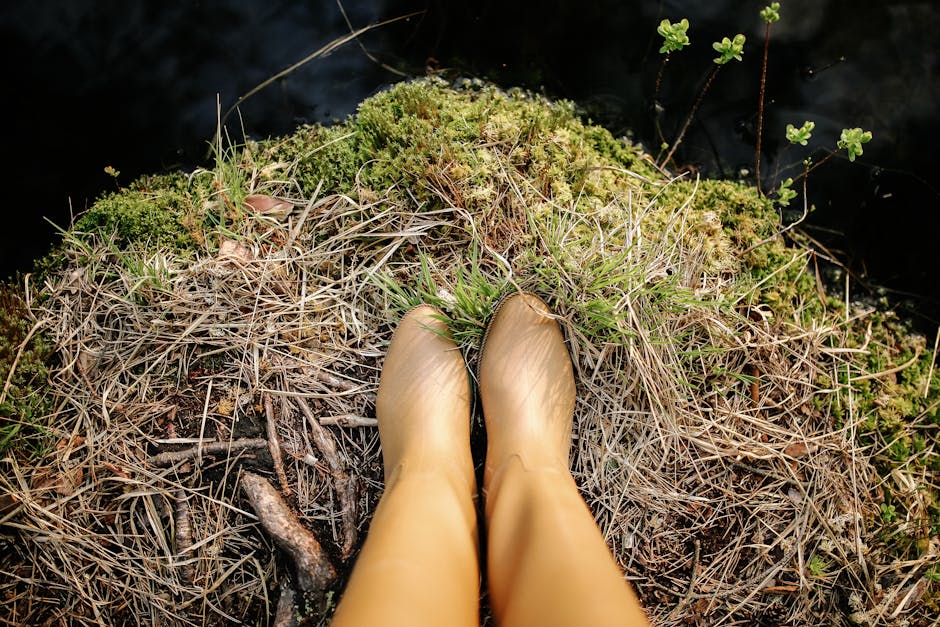 Person wearing Hunter wellington boots at a muddy British summer festival