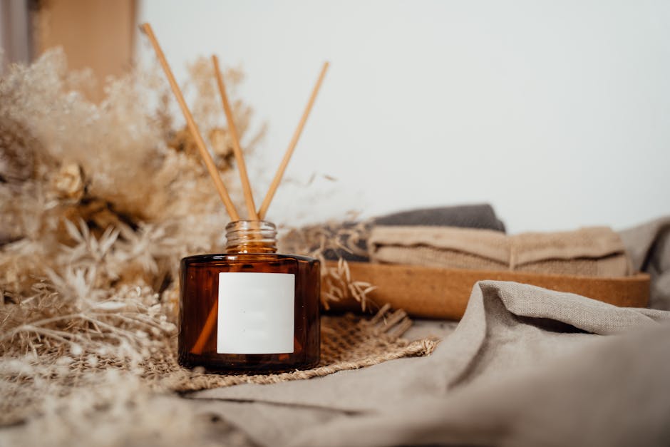 A designer reed diffuser on a wooden shelf in a bright, airy living room