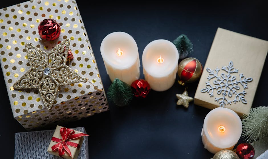 Designer candles and home fragrance products arranged as a gift flatlay with tissue paper and ribbon