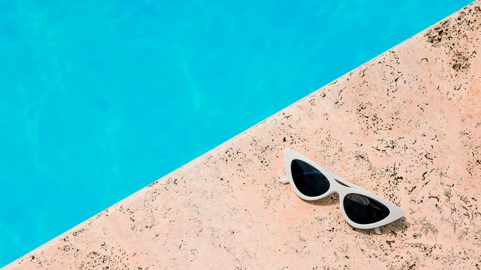 Assortment of designer sunglasses laid out on a bright white surface for summer 2026