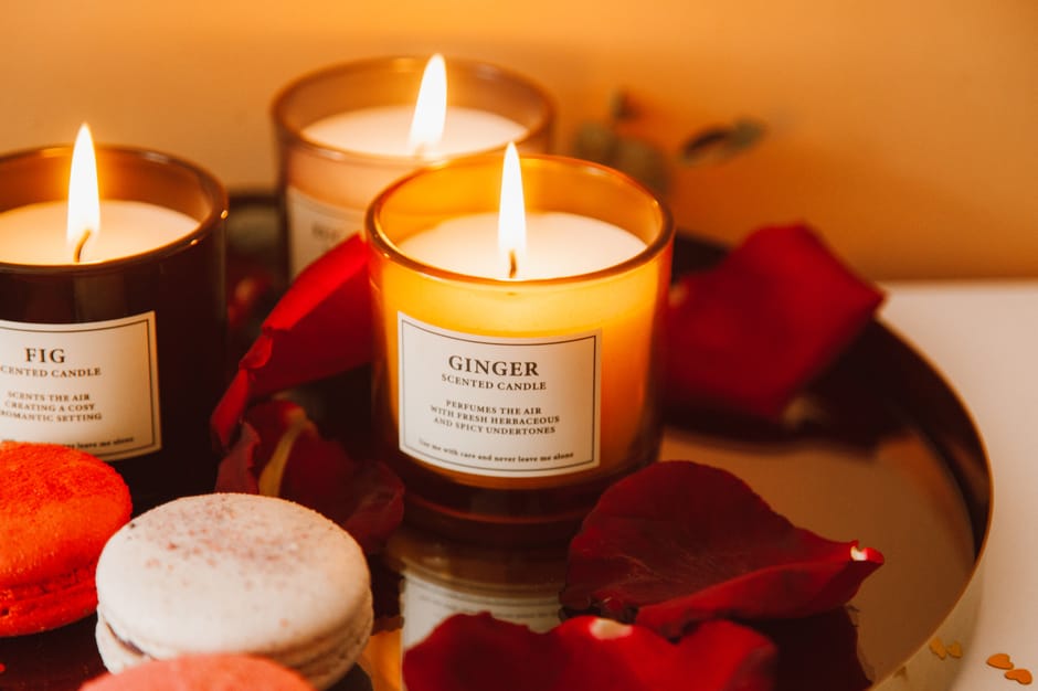 A collection of luxury scented candles and homeware gifts arranged on a marble surface