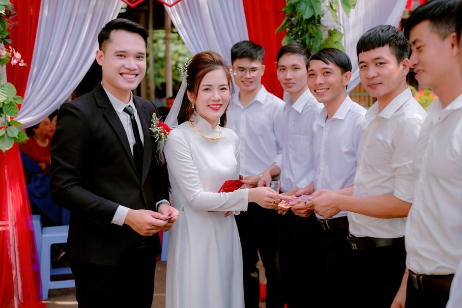 Happy newlyweds opening beautifully wrapped wedding gifts together at home