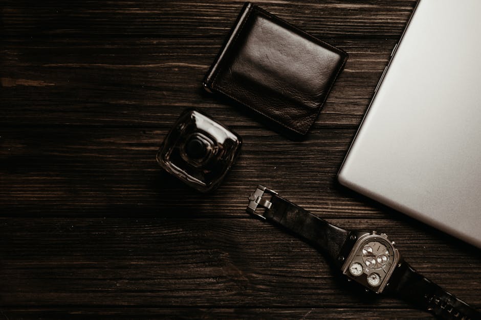 Designer leather bifold wallet and accessories laid flat, ideal Father's Day gift for him