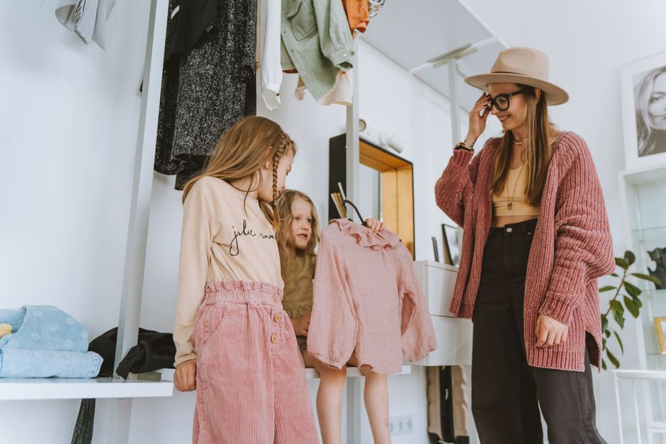 Parent and child selecting school clothing together in a shop