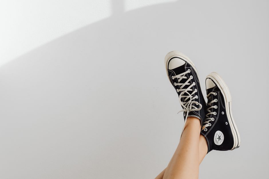 Black sneakers displayed against a white background, highlighting casual fashion style.
