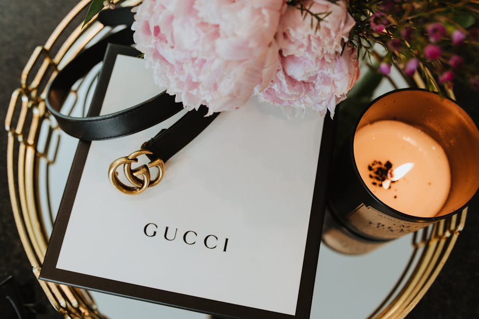 Close-up of premium leather sandals and a linen tote bag on a sun-drenched wooden surface