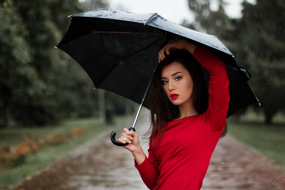 A stylish woman in a lightweight trench coat and sundress on a bright but cloudy British summer day