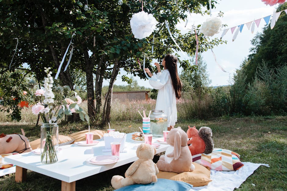 Elegantly decorated summer garden party table with flowers, glassware and candles