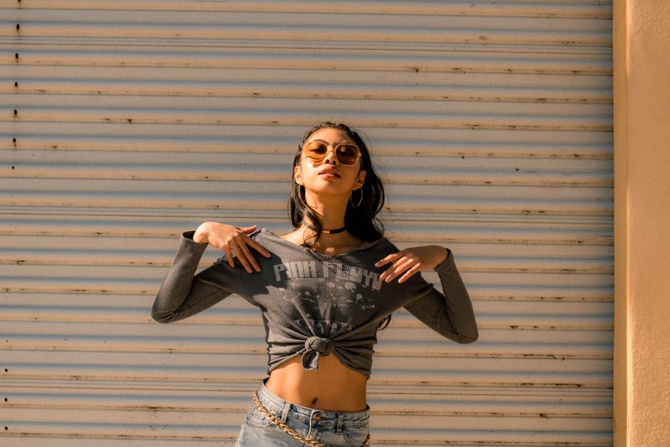 A woman wearing stylish oversized sunglasses outdoors in bright summer light
