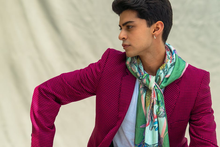 Folded luxury silk scarf in rich jewel tones displayed on a wooden surface