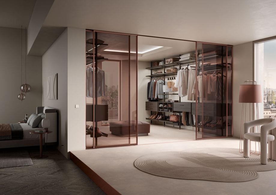 A curated selection of premium designer clothing and accessories arranged on a rail