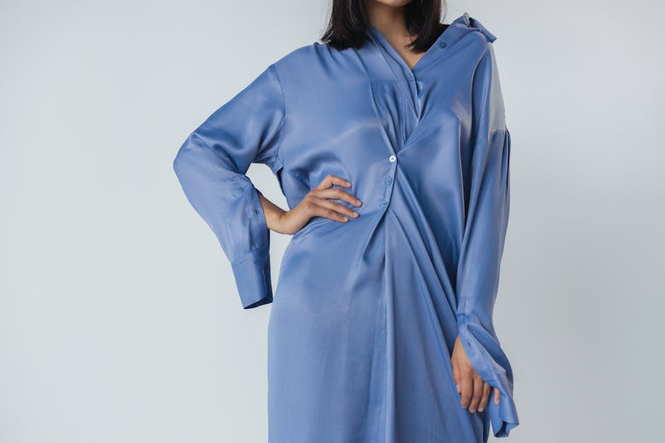 Minimal fluid silk midi dress in a warm neutral tone styled for quiet luxury summer dressing