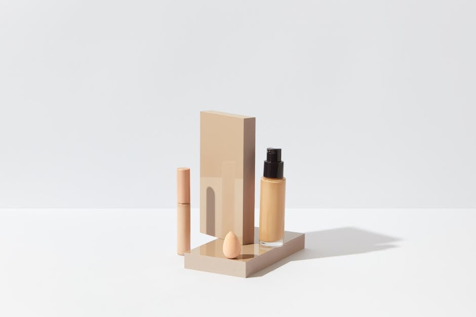 Luxury long-wear foundation and makeup products arranged on a marble surface for a summer beauty flatlay