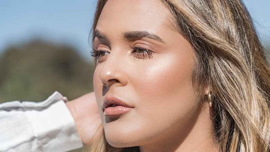Woman with glowing, flawless makeup in bright summer sunshine, demonstrating sweat-proof beauty