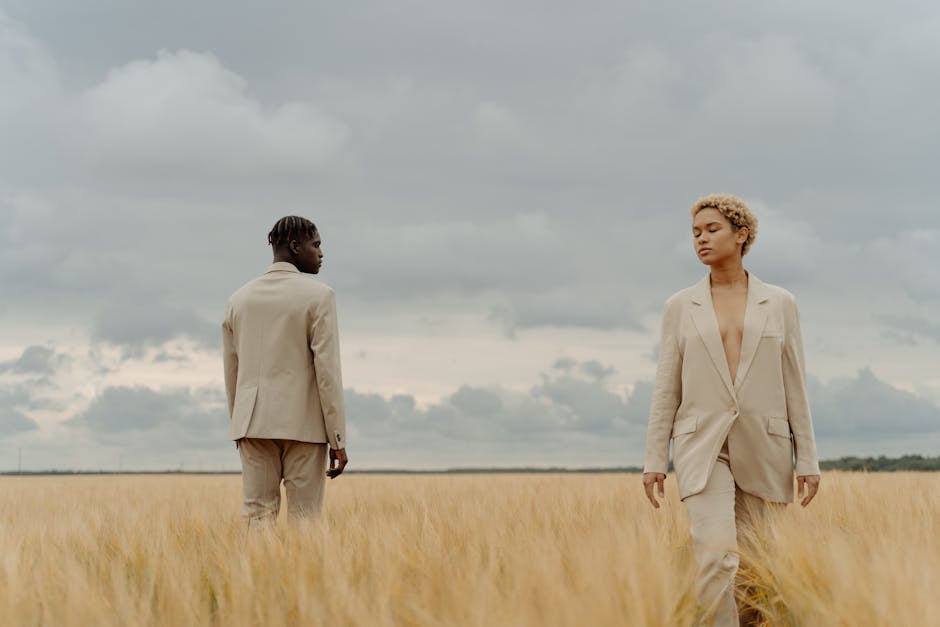 Neatly folded linen trousers in neutral tones displayed on a wooden surface