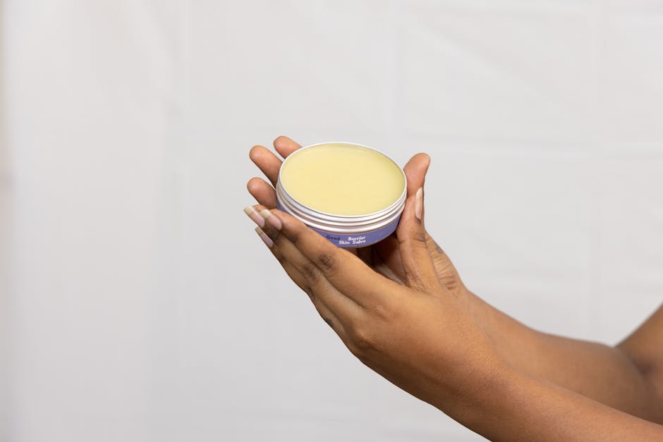 A woman applying SPF moisturiser to her face in front of a mirror