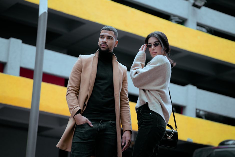 Trendy couple showcasing fashion in front of a colorful urban backdrop in İstanbul, Turkey.