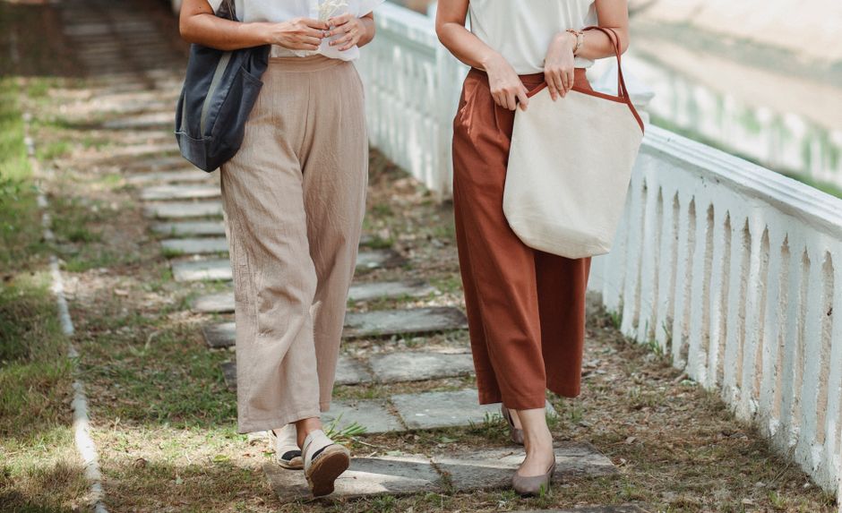 Smart casual summer outfit with white linen trousers, a satin blouse, and loafers