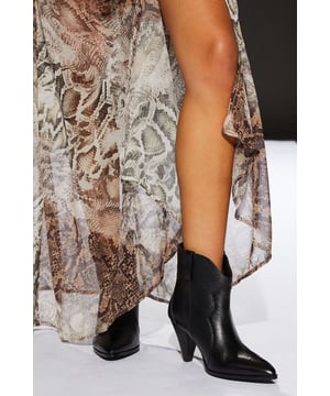 Genuine leather construction for durability and style
        Western-inspired design with pointed toe
        High heel between 7 and 9cm for a confident stride
        Versatile black colour suitable for various outfits
        Ankle-length cut for easy wear and removal
    
    Step into the spotlight with these striking Runway Leather Western Boots from RUNWAY 1.8.1.8. These boots are the epitome of day-to-night versatility, seamlessly transitioning from office chic to evening glamour. The genuine leather upper ensures longevity and a luxurious feel, while the Western-inspired silhouette adds a touch of rugged elegance to any ensemble. Whether paired with tailored trousers for a sophisticated work look or styled with a flowing maxi dress for a night out, these boots are sure to make a statement. The high heel provides a flattering lift, perfect for those seeking to add height and confidence to their stride. Embrace the fusion of contemporary fashion and timeless Western charm with these must-have boots that are destined to become a staple in your wardrobe.