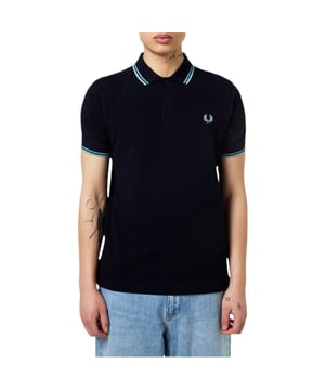 The Twin Tipped Fred Perry Polo Shirt by Fred Perry is a short sleeved polo shirt that has been made from Fred Perry's classic cotton piqué, in a contemporary adaptation of Fred's famous streamlined fit. Available in a diverse range of colourways - each with their own unique story. Featuring the signature Fred Perry wreath logo to the chest and twin tipping to the collar and cuffs.
