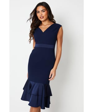 Elegant V-neckline accentuating the dcolletage
Sophisticated peplum detail creating a flattering silhouette
Sleeveless design allowing for effortless movement
Fluted hem adding a feminine touch
crepe fabric with a luxurious drape

Exuding timeless sophistication, this dress is a refined choice for formal occasions. The sleek silhouette, enhanced by the peplum detail, creates a flattering hourglass shape. Pair it with statement jewellery and heels for a polished look suitable for weddings, races, or any elegant event where you wish to radiate effortless style and grace.