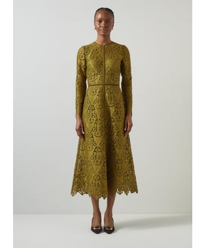 Experience elegance with the Gracie velvet trimmed lace dress in a stunning green. Featuring intricate embroidery cutwork, a velvet ribbon, back zip, and crafted from quality fabric with a floral design and full length sleeves. Perfectly pair it with your favourite heels for an enchanting evening look.