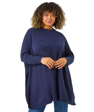 Curve High Neck Cable Knit Poncho from Roman. Wrap up warm in our trendy Curve cable knit poncho, an Autumn Winter must-have to your collection. Featuring a cosy high ribbed neckline, this stylish knit boasts a cable knit yoke detail for added flair. The full length sleeves give a modern touch, while the ribbed hem provides a flattering fit. Pair with jeans and trainers for an effortless stylish look that will keep you warm all season long!