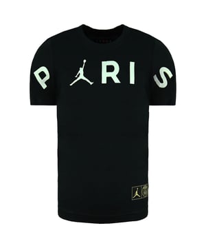 The Nike Jordan x Paris Saint-Germain Header Kids Black T-Shirt is a stylish and sporty collaboration between two iconic brands, Nike's Jordan and the football (soccer) club Paris Saint-Germain (PSG). This t-shirt combines streetwear aesthetics with the passion of football fandom. Here are some key features and information about this kids' t-shirt:

 1. Collaboration with PSG:  This t-shirt is part of a collaboration between Nike's Jordan brand and PSG, a prestigious football club based in Paris. It's a representation of the intersection between sports and streetwear culture.

 2. Black Color:  The t-shirt comes in a sleek black color, offering a modern and versatile look that can be paired with various bottoms.

 3. Kids' Sizing:  Designed for kids, this t-shirt offers a comfortable and age-appropriate fit. It's suitable for young fans of both Jordan and PSG.

 4. Jordan Jumpman Logo:  Look for the iconic Jumpman logo, a symbol of the Jordan brand, on the t-shirt. It signifies the collaboration and adds a touch of streetwear flair.

 5. PSG Logo:  The Paris Saint-Germain logo is often featured on the t-shirt, representing the football club and showcasing the collaboration's authenticity.

 6. Short Sleeves:  The short sleeves make this t-shirt suitable for warm weather or for layering under jackets and hoodies in cooler seasons.

 7. Crew Neck:  The classic crew neck design provides a comfortable and timeless fit.

 8. Comfortable Fabric:  Nike is known for using high-quality materials, and this t-shirt is likely made from soft and breathable fabric to ensure comfort for active kids.

 9. Versatile Styling:  Whether your child is a fan of Jordan, PSG, or simply enjoys stylish and sporty fashion, this t-shirt can be easily incorporated into their casual and athletic outfits.