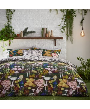 Mushrooms are enjoying their moment in home and fashion designs right now! This is reflected by the amazingly detailed hand-painted Amanita duvet cover set which celebrates the intricate world of fascinating fungi and mystical mushrooms. They glow brightly against the dramatic coloured background, which gives this design a unique twist, alongside surrounding organic shapes. The abstract printed reverse is inspired by the textural underside of a mushroom and is in natural tones for a more neutral look if desired. A fabulous on-trend design which will add both intrigue and a hint of mystery to your bedroom.