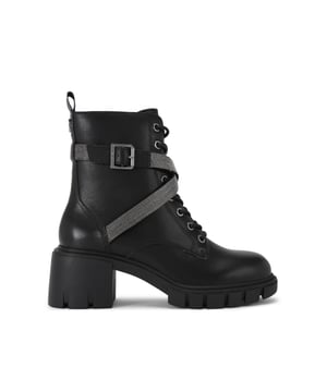 The Ignite Strap is a heeled boot crafted from a black leather. There is a crystal embellished strap around the ankle which is fastened with a buckle. The heel is in a large block style. Heel height: 6cm.