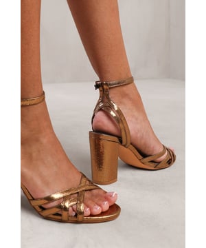 Step out in style and sophistication with our Erin Wide Fit Mid Block Heel with Cross Over Strap Detailing. These stunning shoes are designed to elevate your outfit and add a touch of glamour to your every step.Key Features:



Strappy Design: The single-strap detail adds an elegant and polished touch to these shoes, making them the perfect option for those who want to make a fashion statement.

Comfortable Height: The mid-high block heel provides stability and support, while the cushioned insole ensures all-day comfort. Walk confidently knowing that your feet will stay comfortable, no matter where the day takes you.


Specifications:


Heel Height: 2’ (5.08cm) approx
Strap Detail: Single-strap design adds elegance and polish to these shoes
Closure: Buckle closure for a secure and adjustable fit

Elevate your style and make a statement with our Erin Wide Fit Mid Block Heel with Cross Over Strap Detailing. These shoes combine fashion and functionality, allowing you to showcase your individuality while enjoying all-day comfort. Step out with confidence and embrace your inner trendsetter.
