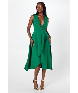 Elegant twist front design creating a flattering wrap effect
        Plunging V-neckline for a daring and sophisticated look
        Sleeveless silhouette perfect for warm-weather occasions
        Midi length with a graceful asymmetric hemline
        Crafted from crepe fabric for a luxurious drape and feel
    
    Make a striking entrance at your next formal event with this captivating twist front wrap skirt crepe midi dress from Coast. The dress showcases a bold plunging neckline that exudes confidence, while the clever twist front design creates a flattering wrap effect that accentuates your silhouette. The midi length with its asymmetric hemline adds a touch of drama and movement, perfect for garden parties or race day events. Style this versatile piece with strappy metallic heels and a clutch bag for a polished look. For cooler evenings, drape a lightweight pashmina over your shoulders. This dress is an ideal choice for weddings, cocktail parties, or any occasion where you want to make a lasting impression with effortless elegance.