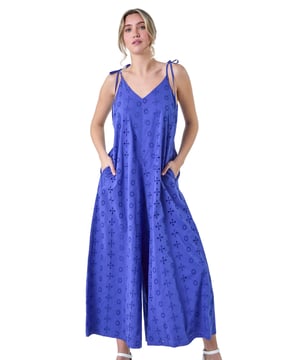 Cotton Broderie Pocket Wide Leg Jumpsuit from Roman. Perfect for Summer, our new Dusk jumpsuit is destined for your holiday wardrobe. Created with tie detail straps and a flattering v-neckline, it is crafted from a cool cotton broderie fabric with embroidery detail throughout. The floaty wide leg silhouette is ideal for the warmer weather, topped off with handy side pockets for your everyday essentials. Pair with sandals and a denim jacket for a relaxed look!