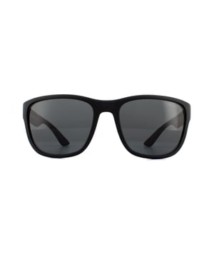 Prada Sport Sunglasses PS01US DG05S0 Black Rubber Grey are an easy to wear rectangular style. The bold style features thick temples with the red Prada Sport logo. A rubberised finish gives a sporty feel and the rubber inserts on the insides of the temples help to hold the sunglasses in place..