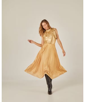 Esta Blusa dorada es una prenda única que te permitirá destacar con elegancia y glamour. Con su fit relajado y lazada en el hombro, te brinda un look sofisticado y femenino. El tejido metalizado color oro le da un toque lujoso y chic. 

Blusa de mujer recta sin manga con cuello subido y lazada en hombro.
Tejido metalizado color oro.