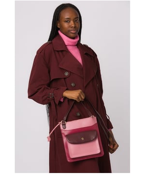 Handcrafted from genuine leather, the 'Lauryn' cross body bag from Conkca London features a beautifully textured finish. A zip-over top secures a central compartment lined with 100% untreated cotton which is complemented by two interior pockets, ideal for your phone and keys. Additional storage space is provided by two full-length pockets alongside a magnetic press stud secured front pocket. Finshed with an adjustable leather strap and adorned with the inimiatable Conkca London squirrel charm.