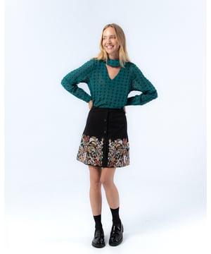 La falda mini negra Carmina te hará sentir única con su bordado en tonos otoñales. Envuélvete con su elegancia.
  
  
  
  Falda con cintura elástica.
  
  Bordado en delantero y espalda.
  
  Botones decorativos.