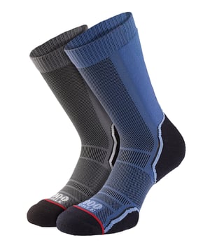 1000 Mile Men's Walking Sock Single LayerIntroducing the Men's Trek Single Layer Sock, your perfect companion for leisure hiking, trail running, walking, or mountain biking. Designed with lightweight comfort and support in mind, these socks offer maximum cushioning for your achilles tendon and extra padding on the toes and ball of the foot. Crafted from a soft Merino wool blend, these socks minimize friction without feeling bulky. The moisture-wicking properties of the merino wool keep your feet cool and dry, and they dry quickly after washing. The natural anti-bacterial qualities of the wool keep your feet feeling fresh, especially during longer distances. With ventilation zones on the top, your feet can breathe easily, staying cool for extended periods. The arch bracing provides additional support and a personalized fit, while the flat toe seam eliminates friction along the toes. Each pack includes two mixed pairs, featuring a navy and purple pair for ladies, and a navy and charcoal pair for men. Upgrade your outdoor adventures with the Men's Trek Single Layer Sock.Extra Product DetailsLightweight comfort for leisure hiking, running, walking, or biking.Maximum cushioning and support for all activities.Soft Merino wool blend reduces friction, without bulkiness.Moisture-wicking and quick-drying for cool and dry feet.Natural anti-bacterial qualities keep feet fresh on long distances.Ventilation zones ensure breathability and coolness.Arch bracing for added support and custom fit.Twin pack: variety of colors for men and women.