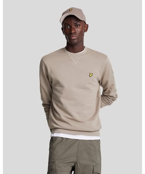 Mens Lyle And Scott Crew Neck Sweatshirt in taupe.- Ribbed crew neckline featuring a ribbed V panel.- Long sleeves.- Ribbed cuffs & waistband.- Lyle & Scott golden eagle embroidered to the left of the chest.- Regular fit.- 100% Cotton.  - Ref: ML424VOGX302