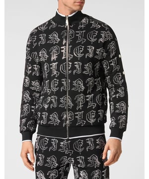 Elija correr con estilo con la singularidad que identifica el estilo de Plein. Hemos diseñado este chándal de forro polar de algodón elástico con pedrería.   Forro polar de algodón con letras de pedrería de estilo gótico.   Pantalón y parte superior con botones laterales de color en contraste    Cierre de cremallera   Bolsillos con aberturas   Cintura con cordón de ajuste de tope   Dobladillos con remates de punto elástico