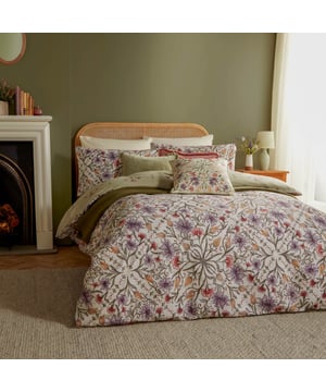 Transform your bedroom into a serene oasis with the Tilda Floral Duvet Cover Set. Infused with the elegance of floral paintings on ceramics, its captivating tile pattern in calming hues evokes a sense of nature's tranquility. The reverse side, adorned in soft sage green florals, offers a harmonious retreat. Crafted from cotton-rich fabric with a 180 thread count, it promises both comfort and style. Ideal for those who cherish the interplay of print and nature, this set gracefully marries boho charm with modern sophistication, making every night a restful escape into beauty. 230 x 220cm