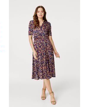Add a comfortable jersey dress to your wardrobe with this printed midi. It has a v-neck with a faux wrap front, 1/2 sleeves, a flattering ruched waist and a straight midi length skirt. Pair with heels or boots for a go-to style to wear during transitional seasons.