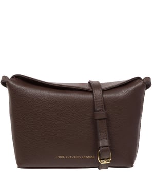 The 'Lolo' cross body bag from the Pure Luxuries Marylebone collection is handcrafted from high-quality, genuine Nappa leather with a natural super-soft touch. The bag is secured by a magnetic closure which opens to reveal a 100% cotton-lined interior and includes two slip pockets. Features gold-coloured metal fittings alongside the adjustable slim leather strap, with a maximum drop length of 65cm. The Pure Luxuries logo is embossed in gold foil for a beautifully simple finishing touch.