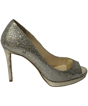 VINTAGE, RRP AS NEW
Jimmy Choo has come out with yet another pair of simple yet contemporary pumps. These exquisite Luna pumps from Jimmy Choo will bring just the right amount of elegance to your outfit. They are created using glitter and lamé fabric on the exterior, with peep toes and 12 cm heels defining their shape.

Jimmy Choo Metallic Luna Open Toe Pumps in Gold Leather
Condition: Very good, with box
Sign of wear: Fair sign of wear on insoles and soles, some marks on insoles
Size: EU 35.5/US 5.5
Material: Leather
SKU: 143255