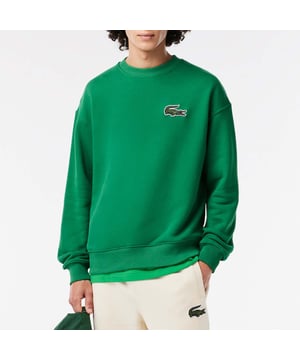 Unisex Lacoste Loose Fit Crocodile Badge Jogger Sweatshirt.- Loose fit, large cut, lowed shoulders.- Fleece crew neck.- Large crocodile on chest.- Embroidered crocodile sewn onto nape of the neck.- Organic unbrushed cotton fleece.