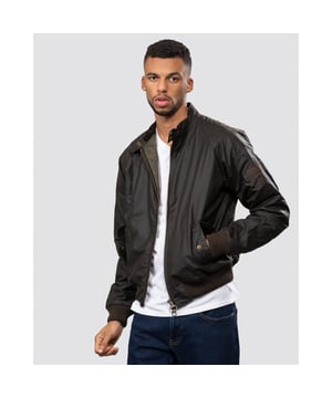 From the Steve McQueen™ International collection, the Merchant jacket is a bomber-style waxed jacket made with a tough waxed cotton outer, inspired by the jackets worn by the American actor and racer.
Durable enough for everyday, the Merchant is a simple, robust jacket that's medium weight with a quilted nylon lining for extra warmth. A corduroy-lined funnel neck with stud close gives the classic International look. Ribbed fabric on the sleeves and waist allow extra wind protection and stud-close angled pockets keep hands free.

Tailored Fit
99% Cotton, 1% Elastane
Denim, rinse wash
Barbour International denim branding pack with waist rider, leather patch, hang loop and tear off fit label.
Sponge clean only&nbsp;