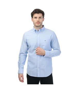 Mens Gant Regular Oxford A. Shield Shirt in blue.- Button down collar.- Long sleeves with adjustable cuffs.- Full button fastening.- Pocket to chest.- GANT Logo embroidered at chest.- Box pleat with our signature locker loop at the back.- Curved hem.- Regular fit.- 100% Cotton. - Ref: 3000800468